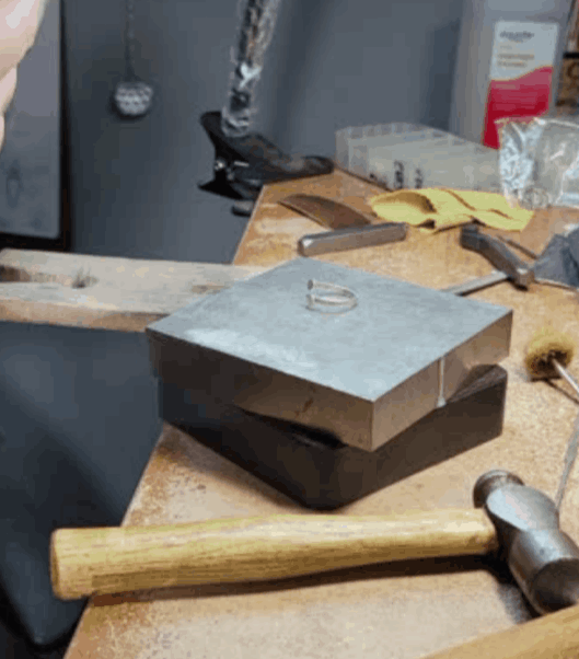 Ring on block with hammer in front